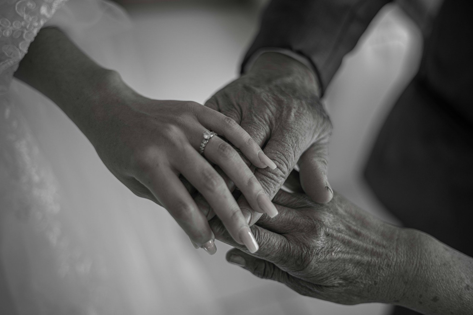 a close-up of a woman and a man holding hands